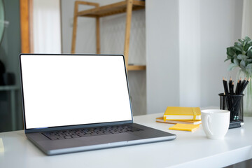 Fototapeta premium Mockup computer laptop with blank screen on white office desk.