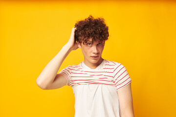 portrait of a young curly man striped t shirt posing summer clothing isolated background unaltered