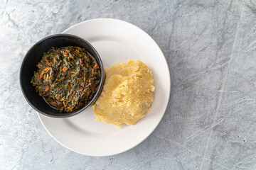 Nigerian Spicy hot Vegetable soup served with Eba or Garri