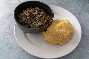 Nigerian Spicy hot Vegetable soup served with Eba or Garri