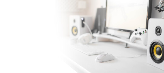 White modern wired gaming mouse in a white comfortable gamer workspace. Close-up of a special device