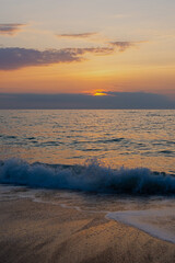 Orange sea sunset. The beautiful sun sets behind a large cloud. Warm mother-of-pearl light. Summer...