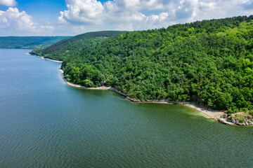 Obraz na płótnie Canvas Aerial view of Bakotinskaya bay, Ukraine, scenic view of the Dniester river, rocks, forests and mountains above the blue water of the lake, sunny day