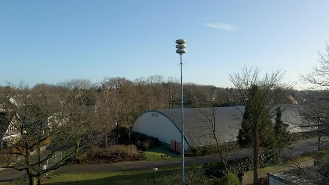 Wide jib up of Dutch air raid siren in the Netherlands