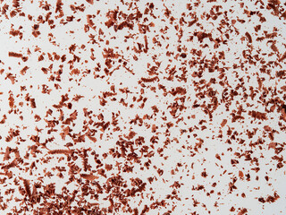 Dark chocolate pieces isolated on white background. Chocolate bar chunks, shavings and cocoa crumbs Top view.