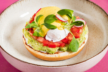 Gourmet meal with fresh poached egg yolk and avocado