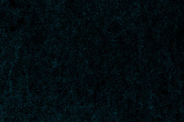 Dark cyan color scattered grunge texture on isolated black paper for background