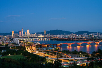 Fototapeta na wymiar Seoul city skyline, National Assembly building, Hangang River at night, South Korea. 서울, 여의도, 성산대교, 한강, 저녁, 일몰, 강변북로.