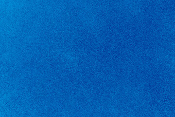 Blue color rough stiff paper surface close up view for texture background