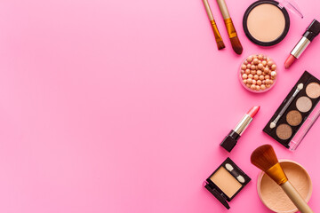 Decorative makeup cosmetic with powder and brushes on color background