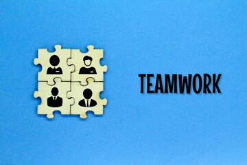 A puzzle with the icon of a group of team workers and the word TEAMWORK. TEAMWORK concept