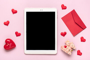 digital tablet for chooses gifts, makes purchase, envelope, red hearts on pink table Top view Flat...