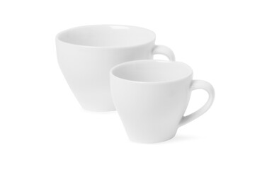 Two white tea cups for drink isolated on white background. Ceramic coffee cup or mug close up. Mock-up classic porcelain utensils. Blank ceramic mug mockup template for branding on white.