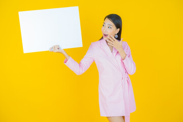 Portrait beautiful young asian woman with empty white billboard