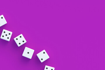 Board games. Addiction to gambling. Casino games. Random winnings. Jackpot. Leisure entertainment for the whole family. Row of dices on violet background. Top view. Copy space. 3d render