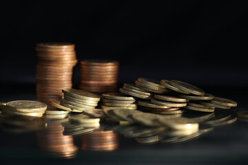 A vertical shot of a pile of golden coins and copper coins.