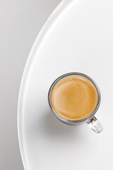 One glass coffee cup with espresso in morning on white table. Aroma, ristretto. Mug of coffee....