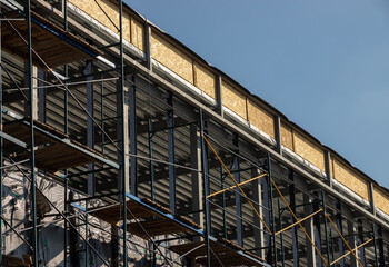 New home Construction of a cement block home with wooden roof trusses view from outside looking in