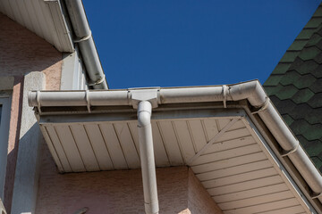 The roof of the house is made of red metal tiles, a beautiful large chimney