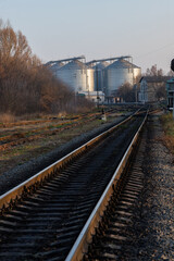 railway track near the factory. Autumn trees and factory premises