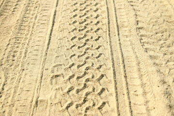 car tire marks in the sand background