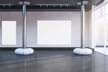 Contemporary concrete exhibition hall interior with empty white mock up posters, decorative elements, sunlight and window with city view. 3D Rendering.