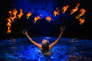 Firedancer woman with fire in water