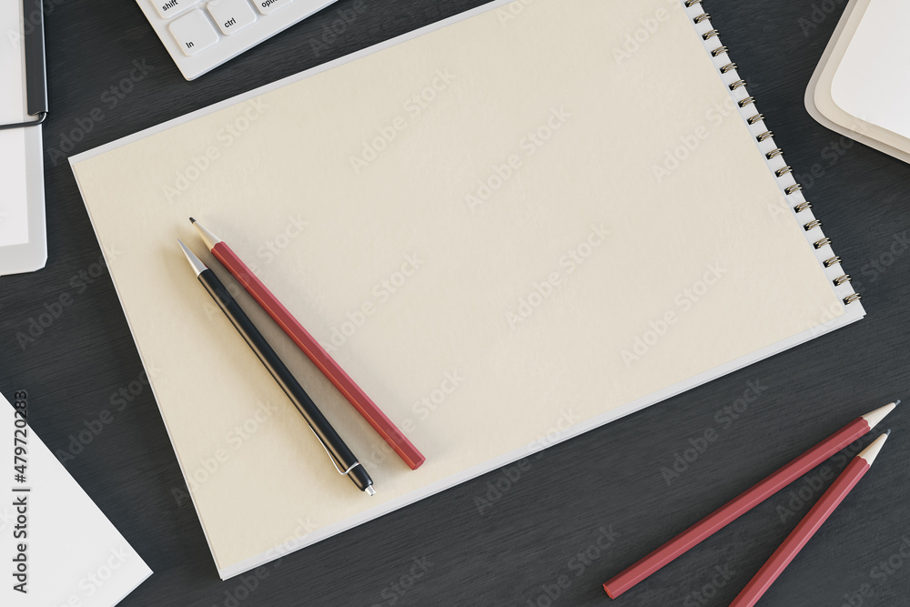 Aufkleber Top view of empty spiral notepad on dark wooden desktop with keyboard and pencils. Drawing, workplace, supplies and art concept. Mock up, 3D Rendering.