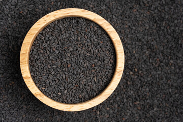 Close-up of Organic Black Sesame seeds on the self background. Top view.