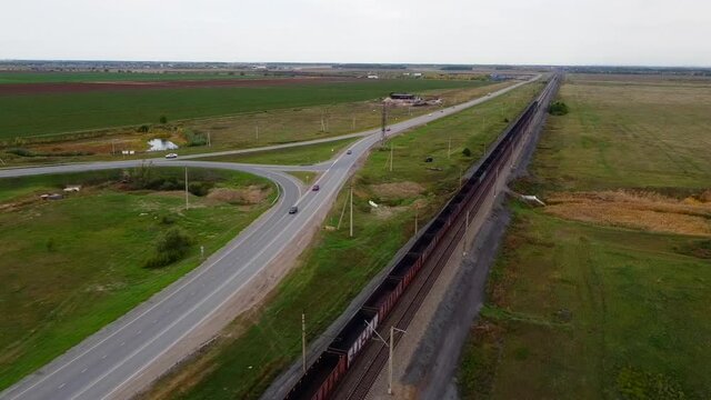 Railway and trains at the station of formation and on the stretch, in summer, during the day from the air. Shooting from a drone.
