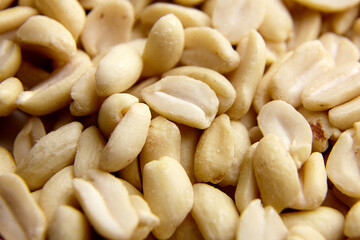 Raw blanched peanuts as food background