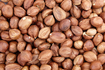Shelled raw hazelnuts background closeup