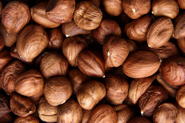 Shelled raw hazelnuts background closeup