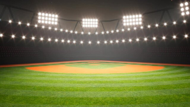 Empty baseball stadium during the night. Grass and orange dirt in the spotlight