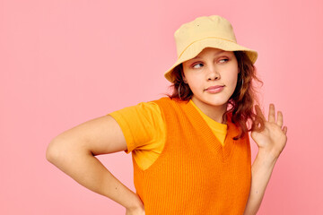 Naklejka premium pretty woman in an orange sweater in yellow hat hand gesture cropped view unaltered
