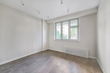 Empty room after repairs in an apartment building. Fresh renovated room with wooden floor