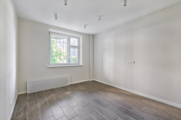 Empty room after repairs in an apartment building. Fresh renovated room with wooden floor