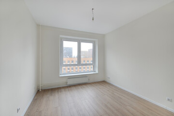 Empty room after repairs in an apartment building. Fresh renovated room with wooden floor