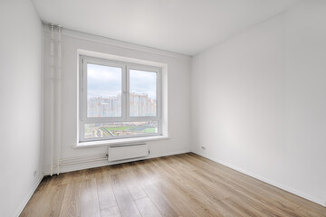 Empty room after repairs in an apartment building. Fresh renovated room with wooden floor
