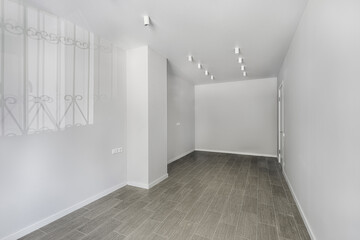 Empty room after repairs in an apartment building. Fresh renovated room with wooden floor