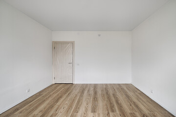 Empty room after repairs in an apartment building. Fresh renovated room with wooden floor