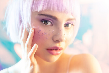 Young modern blond woman with perfect hydrated skin and sparkles on face. Beautiful sensual blonde...
