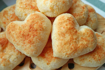 Closeup Pair of Delectable Heart Shaped Fresh Baked Pao de Queijo or Brazilian Cheese Breads on the...