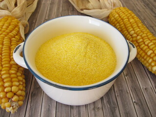 Corn semolina in a pot and maize ears