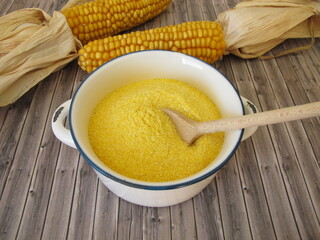 Corn semolina in a pot and maize ears