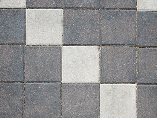 Paving stone background on city street. Mosaic modern pavement background texture close up.