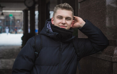 Fototapeta premium Portrait of young blonde guy Nordic appearance, lifestyle of young people. Handsome guy close up, winter day thinking about something