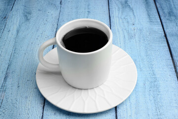 Cup with coffee on a saucer on a colorful bright background. Top and side view. The concept of relaxation, rest, tea drinking.