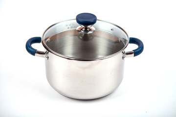 Metal saucepan with a glass lid for cooking soup, food. made of stainless steel. kitchen utensils with a thick bottom for electric, infrared, induction or gas stoves. On an isolated white background.