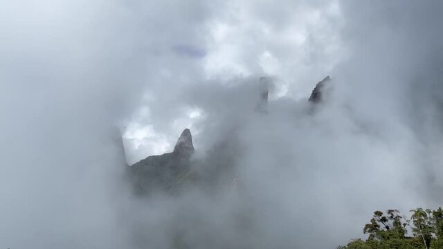 Rising clouds slowly obscuring the view of Postcard panorama landscape of Brazilian mountain range Serra dos Orgaos in Teresopolis, Rio de Janeiro. 60fps normal speed